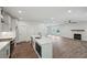Stylish kitchen with a central island, quartz countertops, stainless steel appliances, and an open flow to the living room at 3159 Stonegate Sw Dr, Atlanta, GA 30331