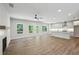 Open living room with hardwood floors, a fireplace, abundant natural light, and seamless transition to a modern kitchen at 3159 Stonegate Sw Dr, Atlanta, GA 30331