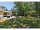 Spacious backyard featuring a patio, deck, grill, and lush green grass at 6380 Concord Rd, Cumming, GA 30028