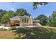 Backyard with a deck and a screened-in porch, surrounded by lush greenery, offering a serene outdoor retreat at 6380 Concord Rd, Cumming, GA 30028