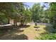 Backyard with a white fence, swing set, garage, and garden, perfect for outdoor activities and enjoyment at 6380 Concord Rd, Cumming, GA 30028