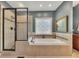 Luxurious bathroom featuring a separate shower and jetted tub at 6380 Concord Rd, Cumming, GA 30028