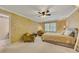 Bright bedroom with a bed, two chairs, and natural light streaming through the window at 6380 Concord Rd, Cumming, GA 30028