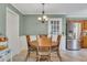 Eat-in kitchen area with wood table set, stainless steel refrigerator, and natural light at 6380 Concord Rd, Cumming, GA 30028