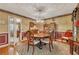 Formal dining room with hardwood floors, wainscoting, and decorative chandelier at 6380 Concord Rd, Cumming, GA 30028