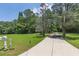 Long driveway to the house with a verdant lawn, mailbox, and lush trees offering a private setting at 6380 Concord Rd, Cumming, GA 30028