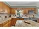 Bright kitchen features granite countertops, stainless steel appliances, and wood cabinets at 6380 Concord Rd, Cumming, GA 30028