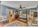 Elegant main bedroom featuring hardwood floors, a four poster bed and ample lighting at 6380 Concord Rd, Cumming, GA 30028