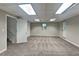 Spacious finished basement with ample lighting, plush carpet, and convenient access to stairs and exterior at 1011 Darvin Nw Ln, Kennesaw, GA 30144