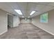 Finished basement with neutral walls and plush carpet, illuminated by recessed lighting and natural light at 1011 Darvin Nw Ln, Kennesaw, GA 30144
