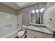 Well-lit bathroom featuring a granite countertop, a combo shower and tub, and a modern sink at 1011 Darvin Nw Ln, Kennesaw, GA 30144