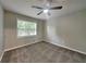Bright bedroom with a large window, neutral carpet, and a modern ceiling fan at 1011 Darvin Nw Ln, Kennesaw, GA 30144