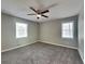 Cozy bedroom featuring plush carpeting, bright windows, and a modern ceiling fan at 1011 Darvin Nw Ln, Kennesaw, GA 30144