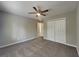 Well-lit bedroom with carpeting, a ceiling fan, and ample storage with double closets at 1011 Darvin Nw Ln, Kennesaw, GA 30144