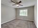 Neutral bedroom with a ceiling fan, and a carpet floor, complimented with a window allowing natural light at 1011 Darvin Nw Ln, Kennesaw, GA 30144