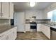 Beautiful kitchen featuring stainless steel appliances, granite countertops, and bright white cabinets at 1011 Darvin Nw Ln, Kennesaw, GA 30144