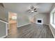 Bright living room with hardwood floors, a ceiling fan, and a fireplace at 1011 Darvin Nw Ln, Kennesaw, GA 30144