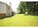Beautiful backyard featuring lush greenery, a privacy fence and a well-manicured lawn at 1455 Duren Farms Dr, Lithonia, GA 30058