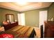 Spacious bedroom with an earthy green wall and a door leading to another room at 1455 Duren Farms Dr, Lithonia, GA 30058