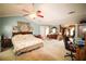Expansive bedroom featuring a sitting area, ceiling fan and ample space at 1455 Duren Farms Dr, Lithonia, GA 30058