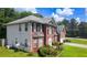 A side view of the home featuring the back side, two-car garage, and landscaping at 1455 Duren Farms Dr, Lithonia, GA 30058