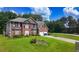 A lush front lawn leads up to a well-maintained brick home with an attached two-car garage at 1455 Duren Farms Dr, Lithonia, GA 30058
