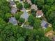 Aerial view of a neighborhood nestled within a dense forest, showcasing the community's tranquil setting at 755 Creek Wind Ct, Johns Creek, GA 30097