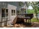 Exterior view of deck with stairs leading down to the manicured lawn and lush landscaping at 755 Creek Wind Ct, Johns Creek, GA 30097