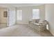 Finished basement with plush carpeting, a comfortable couch and two bright windows at 755 Creek Wind Ct, Johns Creek, GA 30097