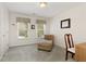 Bedroom with a chaise lounge, framed artwork, and natural light at 755 Creek Wind Ct, Johns Creek, GA 30097