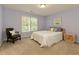 A blue bedroom featuring a window, a bed and a decorative chair at 755 Creek Wind Ct, Johns Creek, GA 30097
