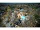 A comprehensive aerial view of the community amenities, showcasing the pool, tennis courts, and playground area at 755 Creek Wind Ct, Johns Creek, GA 30097