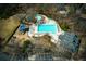 Aerial view of a community pool, playground, and clubhouse, providing a range of recreational options for residents at 755 Creek Wind Ct, Johns Creek, GA 30097