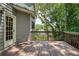Wooden deck with railing with door leading indoors with tree-lined view at 755 Creek Wind Ct, Johns Creek, GA 30097