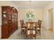 Elegant dining room featuring a dark wood table, chairs, and hutch under a chandelier at 755 Creek Wind Ct, Johns Creek, GA 30097