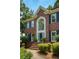 Close up of a brick home with a large arched window above the front door and steps at 755 Creek Wind Ct, Johns Creek, GA 30097