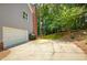 Spacious driveway and attached garage with mature trees at 755 Creek Wind Ct, Johns Creek, GA 30097