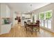 Kitchen with granite countertops, hardwood floors, and dining area with a large window view at 755 Creek Wind Ct, Johns Creek, GA 30097
