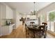 Kitchen with granite countertops, hardwood floors, and dining area with a large window view at 755 Creek Wind Ct, Johns Creek, GA 30097