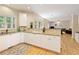 Open-concept kitchen with granite countertops, hardwood floors, and easy access to the living room at 755 Creek Wind Ct, Johns Creek, GA 30097