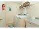 A tidy laundry room with a utility sink, washer, and dryer at 755 Creek Wind Ct, Johns Creek, GA 30097
