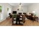 Spacious living room with hardwood floors, a fireplace, natural lighting, and comfortable leather furniture at 755 Creek Wind Ct, Johns Creek, GA 30097