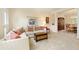 Open-concept living room and dining area with neutral tones, plush carpet and ample natural light at 755 Creek Wind Ct, Johns Creek, GA 30097