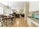 Connected living space with hardwood floors, a dining area, and a glimpse into the spacious living room at 755 Creek Wind Ct, Johns Creek, GA 30097