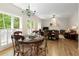 Connected living space with hardwood floors, a dining area, and a glimpse into the spacious living room at 755 Creek Wind Ct, Johns Creek, GA 30097