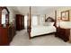 Spacious bedroom with carpet, a four-poster bed, and decorative furnishings at 755 Creek Wind Ct, Johns Creek, GA 30097