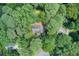An aerial view of a home nestled among trees in a community surrounded by lush greenery at 104 Southfork Dr, Woodstock, GA 30189