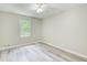 Bedroom with a view showcasing the natural light and wood-look flooring at 104 Southfork Dr, Woodstock, GA 30189