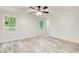Bedroom with wood-look floors, complemented by neutral walls and natural light from large windows at 104 Southfork Dr, Woodstock, GA 30189