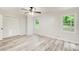 Light-filled bedroom with wood-look floors, a closet, and large windows overlooking the yard at 104 Southfork Dr, Woodstock, GA 30189